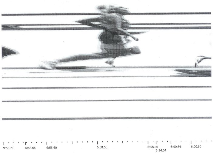 Jeanne takes a mean phototimer picture in her W75 world record mile.