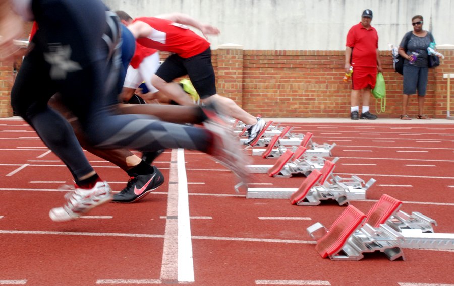 An M35 field blasts off behind white tape, marking true 100-meter start at Wake Forest.