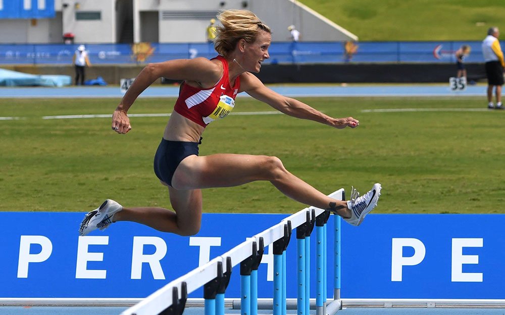 Rachel Guest clears barrier on way to 11.42 hurdles gold. Had 2.5 mps wind been 2.0 or under, mark would broken record of 11.47 by Stephanie Thomas in 2005. Photo by Rob Jerome