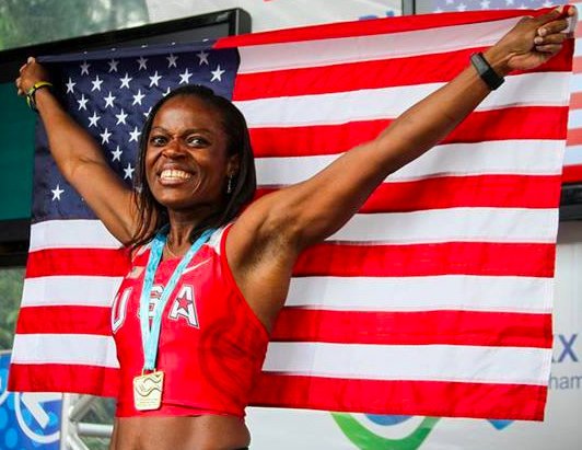 Ruthlyn Greenfield-Webster shows colors after winning gold in W40 triple jump.